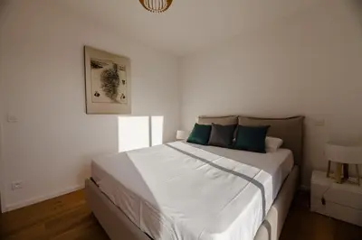 a bedroom with a bed with white sheets and blue pillows at DI SOGNI - Villa d'Archi, 8 pax, pisc Chauffée in Gialla