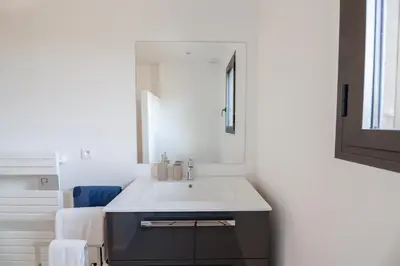 a bathroom with a white sink and a mirror at DI SOGNI - Villa d'Archi, 8 pax, pisc Chauffée in Gialla