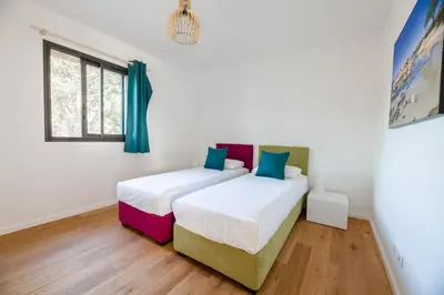 a bedroom with two beds and a window at DI SOGNI - Villa d'Archi, 8 pax, pisc Chauffée in Gialla
