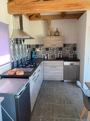 a kitchen with a stove and a counter top at Villa Alivu belle piscine chauffée in Bonifacio
