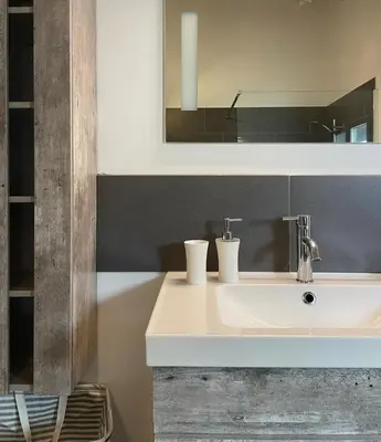 a bathroom with a white sink and a mirror at Villa Alivu belle piscine chauffée in Bonifacio