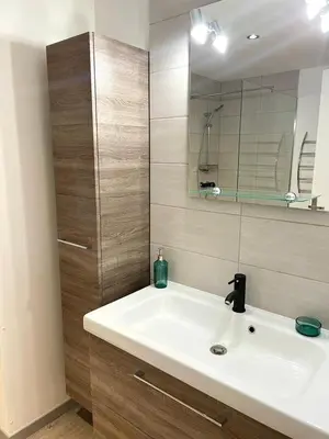 a bathroom with a white sink and a mirror at Villa Alivu belle piscine chauffée in Bonifacio