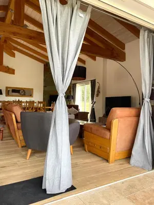 a living room with a couch and a curtain at Villa Alivu belle piscine chauffée in Bonifacio