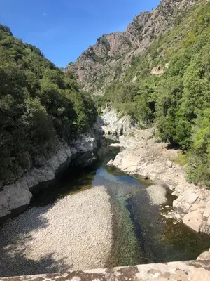 a river in the middle of a canyon at Villa Alivu belle piscine chauffée in Bonifacio
