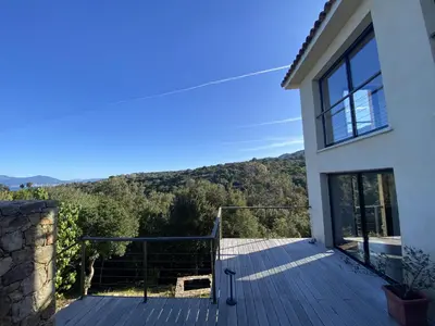 a view from the deck of a house at Magnifique villa vue mer avec piscine in Coti-Chiavari