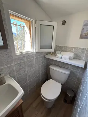a bathroom with a sink and a shower at Rez de villa pour 2 personnes près de Santa Giulia in Sotta