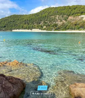 a sign in the water next to a beach at Duplex vue mer EXCEPTIONNELLE en Corse du sud proche plage - le 180Corse in Conca