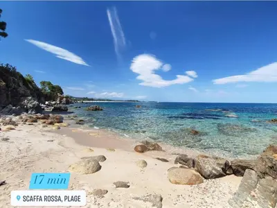 a beach with rocks and the ocean on a sunny day at Duplex vue mer EXCEPTIONNELLE en Corse du sud proche plage - le 180Corse in Conca