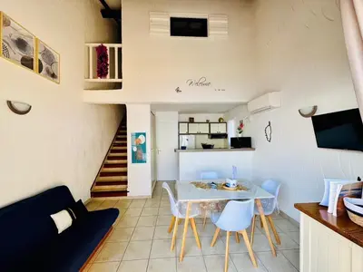 a kitchen and living room with a table and chairs at Duplex vue mer EXCEPTIONNELLE en Corse du sud proche plage - le 180Corse in Conca