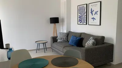 a living room with a couch and a table at Résidence Casa Olea - Studio - T2 - T3 in Cauro