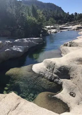 a river with some rocks in the water at Mini Villa St-Lucie Porto-Vecchio vue mer 5mnplage in Zonza