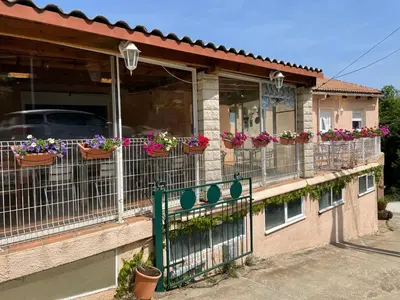 a building with potted flowers on the balcony at chez marie jo Chez marie jo in Cozzano