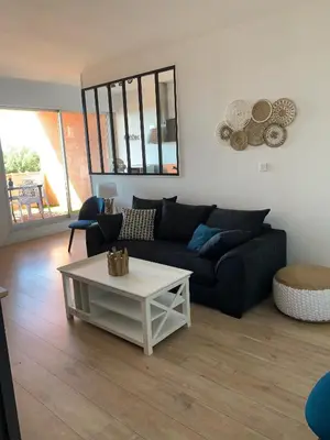 a living room with a couch and a coffee table at Appartement « Marinella » splendide vue mer aux Sanguinaires in Ajaccio