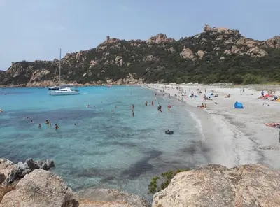 a group of people in the water at a beach at SARTENE t3 CALME ENSOLEILLÉ PARKING PRIVÉ in Sartène
