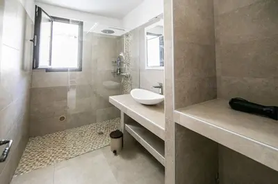 a bathroom with a sink and a shower at SARTENE t3 CALME ENSOLEILLÉ PARKING PRIVÉ in Sartène