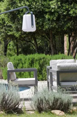 two chairs and a lamp in a garden at Maison 1 in Porto-Vecchio
