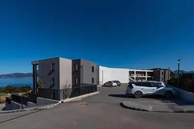 a car parked in a parking lot next to a building at Duplex Horizon vue mer in Pietrosella