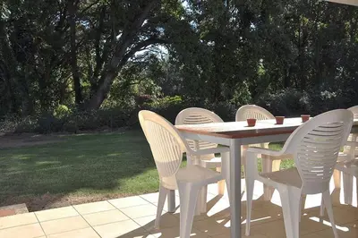 a white table and chairs on a patio at Appartement charmant en Corse avec terrasse au calme in Santa-Lucia-di-Moriani