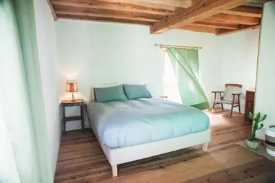 a bedroom with a bed and a table and chairs at Eco lodge Carbonaccio in Chiatra
