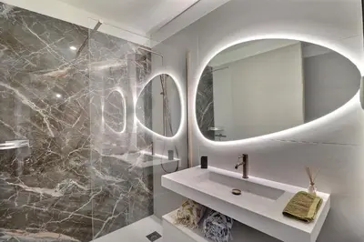 a bathroom with a sink and a mirror at Nouveau ! T2 neuf avec vue imprenable mer in Ajaccio