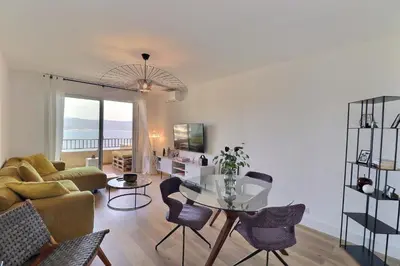 a living room with a couch and a table at Nouveau ! T2 neuf avec vue imprenable mer in Ajaccio