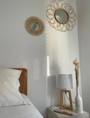 a bedroom with a bed and a mirror on the wall at Nouveau ! T2 neuf avec vue imprenable mer in Ajaccio