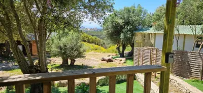a view from the deck of a house with a wooden railing at Grande Chambre tout confort 2 in Bonifacio