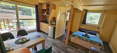 a tiny house with a small bedroom and a kitchen at Grande Chambre tout confort 2 in Bonifacio