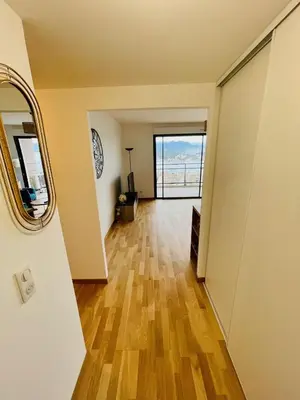 an empty hallway with a mirror and a door at Ajaccio T2 grand standing neuf vue mer centre-ville & plages in Ajaccio