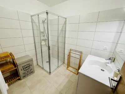 a bathroom with a shower and a sink at Ajaccio T2 grand standing neuf vue mer centre-ville & plages in Ajaccio