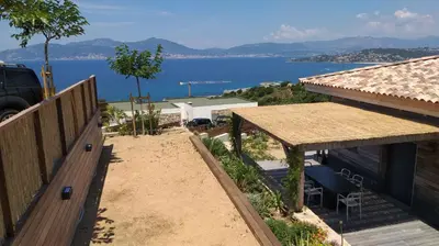 a view of the water from a house at Villa ARIA, piscine, vue mer 120 m2 tout confort - 4 personnes in Pietrosella