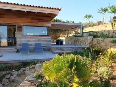 a house with blue chairs and a patio at Villa ARIA, piscine, vue mer 120 m2 tout confort - 4 personnes in Pietrosella