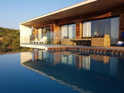 a house with a swimming pool in front of it at Villa ARIA, piscine, vue mer 120 m2 tout confort - 4 personnes in Pietrosella