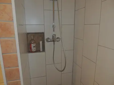a shower with a shower head in a bathroom at Côte Est Pancheraccia Chambre Petit déjeuner in Pancheraccia