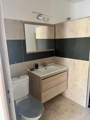 a bathroom with a white toilet and a sink at Campana in Sartène