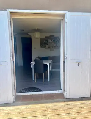 an open door to a dining room with a table at Campana in Sartène