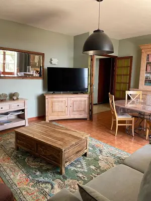 a living room with a flat screen tv and a coffee table at Maison accueillante avec vue sur la mer à Grosseto-Prugna in Grosseto-Prugna