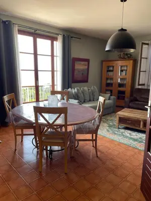 a living room with a table and chairs at Maison accueillante avec vue sur la mer à Grosseto-Prugna in Grosseto-Prugna
