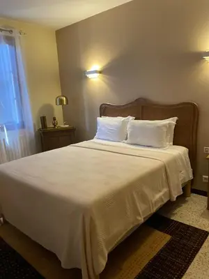 a bedroom with a large bed with white sheets and pillows at Maison accueillante avec vue sur la mer à Grosseto-Prugna in Grosseto-Prugna