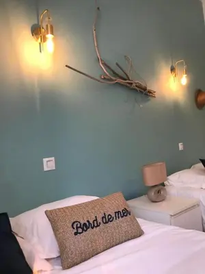 a bedroom with a bed with a sign on it at Villa Terra Casanova pieds dans l'eau à 20 mn d Ajaccio in Villanova