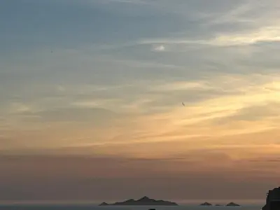 a kite flying in the sky at sunset at SUPERBE APPARTEMENT FACE AUX ILES SANGUINAIRES in Ajaccio