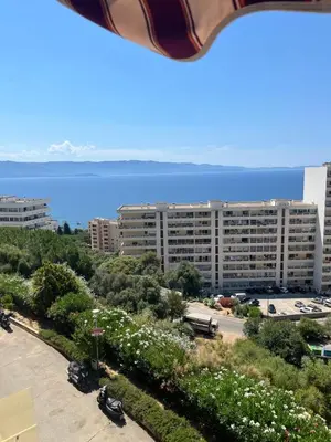 a view of a large building with the ocean in the background at SUPERBE APPARTEMENT FACE AUX ILES SANGUINAIRES in Ajaccio