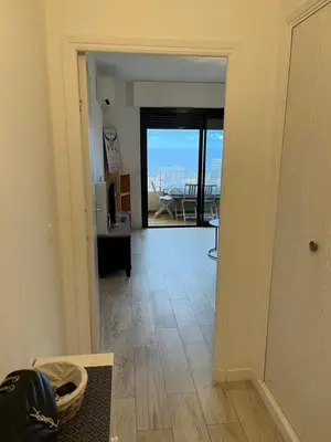 a hallway with a view of a living room at SUPERBE APPARTEMENT FACE AUX ILES SANGUINAIRES in Ajaccio
