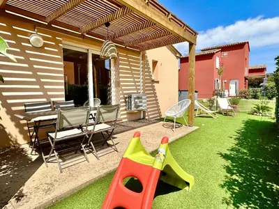 a patio with a table and chairs on a porch at Résidence hôtelière les hameaux de saint cyprien appartement 2 chambres in Lecci