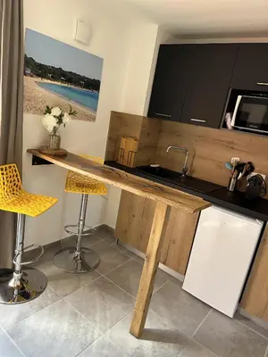 a living room with a couch and a table at Résidence hôtelière les hameaux de saint cyprien 25 M2 in Lecci