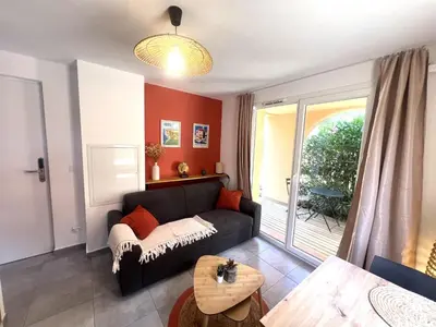 a living room with a couch and a table at Résidence hôtelière les hameaux de saint cyprien 25 M2 in Lecci