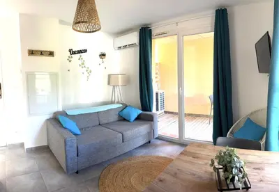 a living room with a couch and a dog on the wall at Résidence hôtelière les hameaux de saint cyprien 25 M2 in Lecci