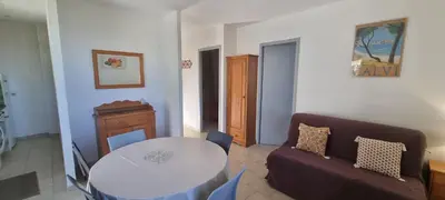 a living room with a table and a couch at Vos vacances à Lama France Corse in Lama