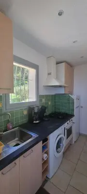 a kitchen with a sink and a washing machine at Vos vacances à Lama France Corse in Lama