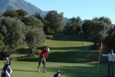 two people playing golf with a dog on a golf course at Vos vacances à Lama France Corse in Lama